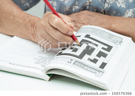 Bangkok, Thailand June 14, 2023 Alzheimer disease AD, Asian elderly woman playing sudoku puzzle game to practice for dementia prevention. 108576366