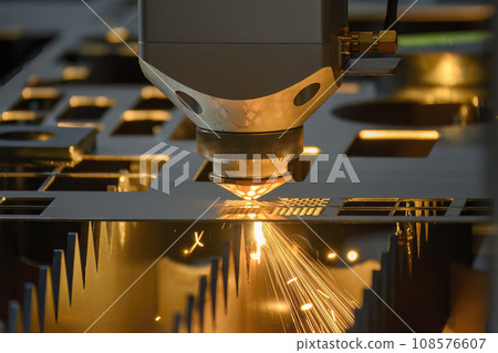 The fiber laser cutting machine  cut the metal plate with the sparkling light. 108576607