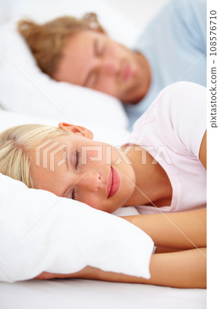 Love, sleep and a couple in a bedroom in the morning to relax in their home together for holiday or vacation. Face, dreaming or eyes closed with a young woman and man in bed in their apartment Love, sleep and a couple in a bedroom in the morning to relax in their home together for holiday or vacation. Face, dreaming or eyes closed with a young woman and man in bed in their apartment 108576710