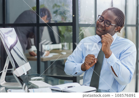 happy man working in the office. raised his hands joyfully 108576891