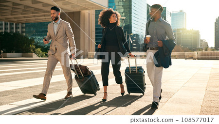Business people, team walking and travel with suitcase in city for corporate, job opportunity and networking. Professional woman and men talking at outdoor hotel or on the way to airport with luggage 108577017