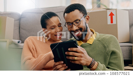 Tablet, black couple and tablet at new home in the morning with social media and moving plan. Happy, web search and technology in a house with smile and decide room color on app with communication Tablet, black couple and tablet at new home in the morning with social media and moving plan. Happy, web search and technology in a house with smile and decide room color on app with communication 108577021