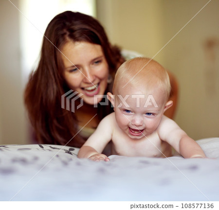 Laughing, playing and a mother with a baby on the bed for bonding, love and care in the morning. Wake up, smile and a mom with a kid or family together in the bedroom of a house for happiness Laughing, playing and a mother with a baby on the bed for bonding, love and care in the morning. Wake up, smile and a mom with a kid or family together in the bedroom of a house for happiness 108577136