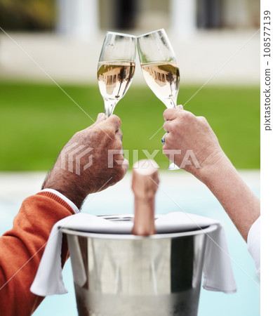 Champagne, toast and hands of senior couple at a hotel for travel, freedom or romantic adventure. Wine, cheers and elderly people with poolside celebration of retirement, success or anniversary Champagne, toast and hands of senior couple at a hotel for travel, freedom or romantic adventure. Wine, cheers and elderly people with poolside celebration of retirement, success or anniversary 108577139