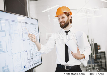 Architect and engineer. Man shows plan of building. TV screen. Architect and engineer. Man shows plan of building. TV screen. 108577281