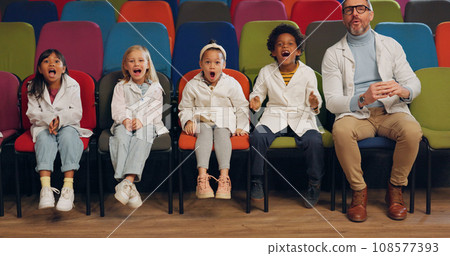 Wow, students and teacher at a science showcase, in the audience as a crowd of school children on an outing. Education, study and kids learning with a professor man in an assembly for a lecture Wow, students and teacher at a science showcase, in the audience as a crowd of school children on an outing. Education, study and kids learning with a professor man in an assembly for a lecture 108577393