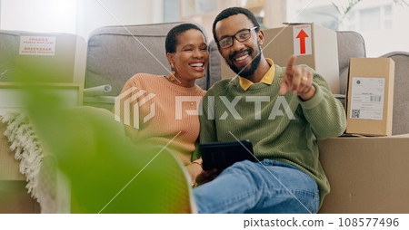 African couple, pointing and new home with tablet, boxes and thinking with discussion, decision and choice. Black woman, man and floor for planning, moving or chat for real estate, property or house 108577496