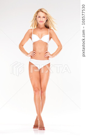 Skincare, confident and portrait of woman in underwear on white background for wellness, beauty and shaving. Spa, salon and isolated person in lingerie for grooming, cosmetics and health in studio 108577530