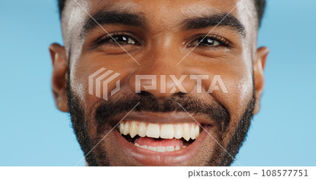 Happy, smile and face of black man in studio, blue background and mockup space with happiness or advertising. Portrait, closeup and marketing for skincare, wellness or healthy dermatology care 108577751