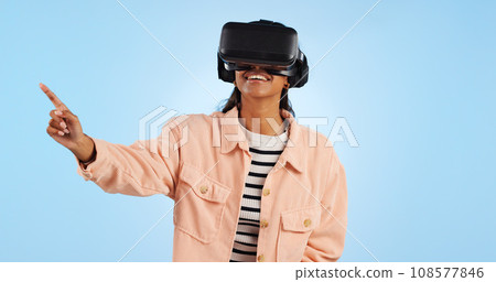 Virtual reality, press on screen and woman with future technology and smile in studio on blue background. Hologram, 3D and metaverse, digital world and high tech with user experience and VR software Virtual reality, press on screen and woman with future technology and smile in studio on blue background. Hologram, 3D and metaverse, digital world and high tech with user experience and VR software 108577846