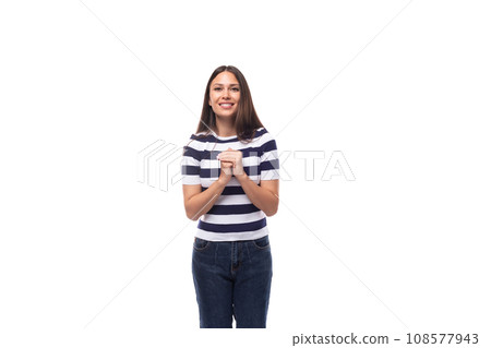 cute young european woman with black straight hair wears striped black and white t-shirt and jeans cute young european woman with black straight hair wears striped black and white t-shirt and jeans 108577943