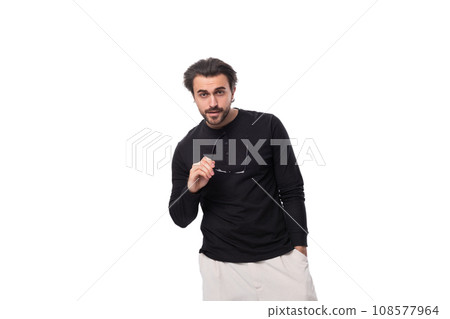 young pensive european guy with stubble and mustache in a black turtleneck and glasses young pensive european guy with stubble and mustache in a black turtleneck and glasses 108577964