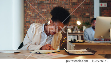 Business woman, writing notes and planning in office for startup goals, administration and schedule or reminder at night. African employee or writer in workspace with notebook, ideas or brainstorming 108578149