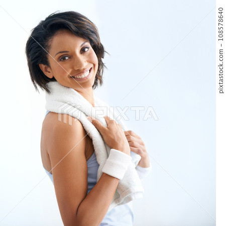 Happiness, fitness portrait and woman with towel for sweat after exercise, pilates workout or yoga aerobics. Sports athlete, active studio training and model smile for challenge on white background Happiness, fitness portrait and woman with towel for sweat after exercise, pilates workout or yoga aerobics. Sports athlete, active studio training and model smile for challenge on white background 108578640
