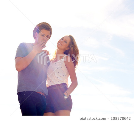Smoking, travel and portrait of couple outdoor relax, bond and a cigarette on sky background. Summer, break and people with love, chilling and enjoying freedom holiday, vacation or weekend together Smoking, travel and portrait of couple outdoor relax, bond and a cigarette on sky background. Summer, break and people with love, chilling and enjoying freedom holiday, vacation or weekend together 108578642