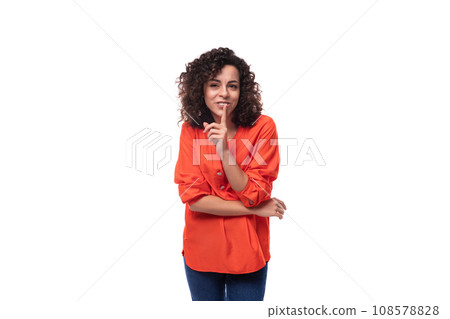 young charming brunette woman dressed in an orange blouse on a white background 108578828