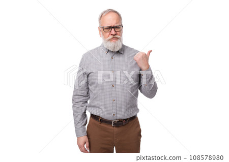 cute smart old man with a mustache and beard in glasses dressed in a shirt and trousers works in a 108578980
