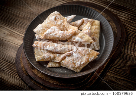 Faworki - traditional Polish crispy dessert. Faworki - traditional Polish crispy dessert. 108579686