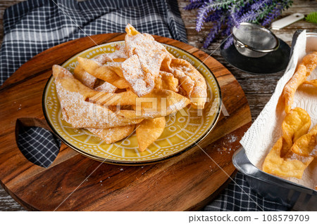 Faworki sprinkled with powdered sugar. Faworki sprinkled with powdered sugar. 108579709