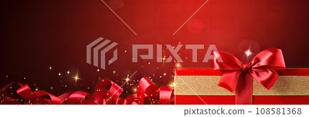 red gift box with gold ribbon on red background. Copy space 108581368