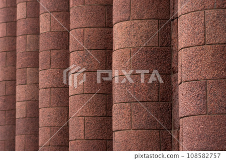 architectural background - massive granite engaged columns on the facade of the building architectural background - massive granite engaged columns on the facade of the building 108582757