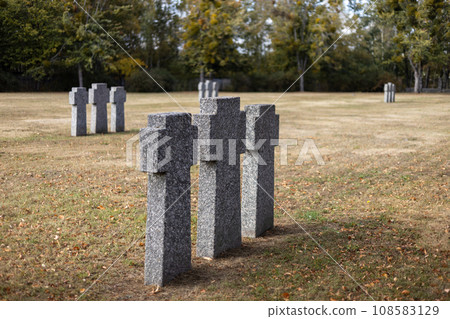 Stone tombstones in the German cemetery in the fall. Beautiful German cemetery near Kyiv. Many dead German soldiers of the dead during the 2nd World War. Stone tombstones in the German cemetery in the fall. Beautiful German cemetery near Kyiv. Many dead German soldiers of the dead during the 2nd World War. 108583129
