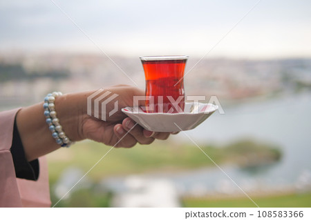 women holding Traditional turkish tea women holding Traditional turkish tea 108583366