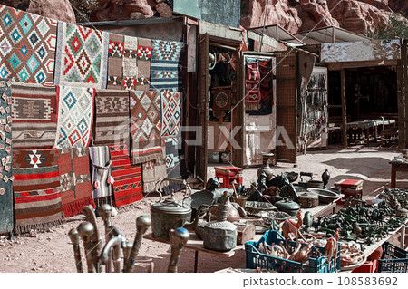 View of an open-air souvenir shop located along the Siq Canyon in the city of Petra, Jordan. View of an open-air souvenir shop located along the Siq Canyon in the city of Petra, Jordan. 108583692