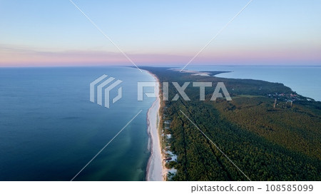 Curonian Spit National Park at sunset, aerial shot. A narrow and long sandy strip of land separating the Curonian Lagoon from the Baltic Sea. Forest and sea. Drone view 108585099