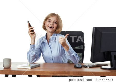 pretty blonde business woman using phone and showing thumbs up gesture in the office pretty blonde business woman using phone and showing thumbs up gesture in the office 108586683