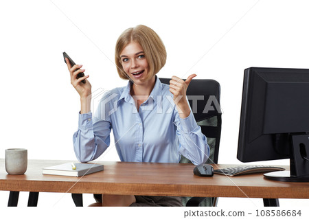 pretty blonde business woman using phone and showing thumbs up gesture in the office pretty blonde business woman using phone and showing thumbs up gesture in the office 108586684