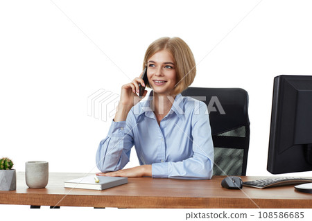 beautiful blonde businesswoman in blue shirt working with PC computer and having phone conversation with client beautiful blonde businesswoman in blue shirt working with PC computer and having phone conversation with client 108586685
