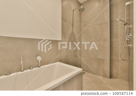 a bathroom with a tub, shower and toilet in the same color as it appears to be used for use a bathroom with a tub, shower and toilet in the same color as it appears to be used for use 108587114