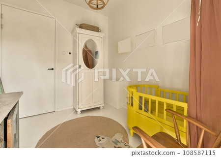a yellow bench in the corner of a room with a mirror on the wall and door to the other room a yellow bench in the corner of a room with a mirror on the wall and door to the other room 108587115
