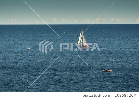 Monaco, lonely vintage sail yacht in sea at sunset, huge sail boat, wealth life of billionaires  108587267