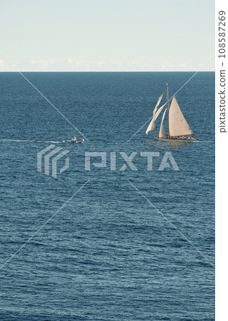 Monaco, lonely vintage sail yacht in sea at sunset, huge sail boat, wealth life of billionaires  108587269
