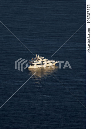 Monaco, lonely mega yacht in sea at sunset, huge motor boat, wealth life of billionaires  108587273