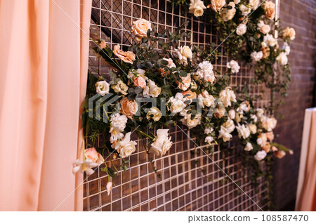 Wedding decor. Photographic area is a stylish wedding decoration. Decorated with flowers, mini florals. Wedding photo zone with flowers. Hand made wedding decorations. Place for taking pictures Wedding decor. Photographic area is a stylish wedding decoration. Decorated with flowers, mini florals. Wedding photo zone with flowers. Hand made wedding decorations. Place for taking pictures 108587470