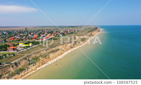 Panorama of sea shore in South Ukraine, Europe. Resort city with nice sand beach and clear blue sea. travel destination, ideal place for comfort vacation on black Sea. Drone photo Panorama of sea shore in South Ukraine, Europe. Resort city with nice sand beach and clear blue sea. travel destination, ideal place for comfort vacation on black Sea. Drone photo 108587525
