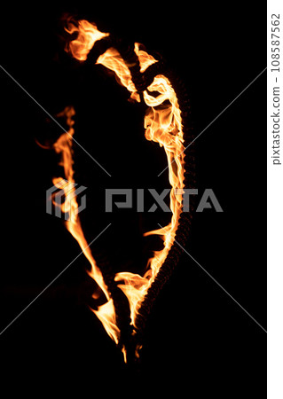 Burning heart with flames. Isolated on dark background. fire show in night. happy valentine's day card. bengal fire burning heart. space for text. wedding or valentine concept. happy new year Burning heart with flames. Isolated on dark background. fire show in night. happy valentine's day card. bengal fire burning heart. space for text. wedding or valentine concept. happy new year 108587562