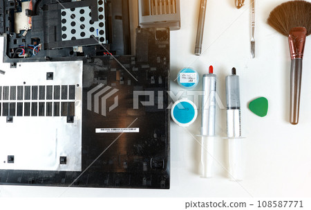 Tools for repair and cleaning pc in workshop. Laptop cleaning tools, brush, screwdrivers. cooling system cooler, disassembled cooling system radiator. Disassembled laptop. laptop cleaning from dust 108587771