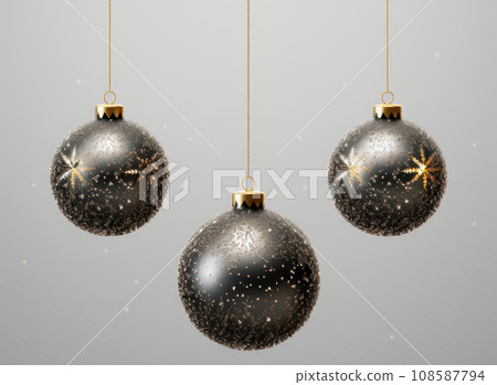 Three Christmas balls in gold and black colors on a black background Three Christmas balls in gold and black colors on a black background 108587794