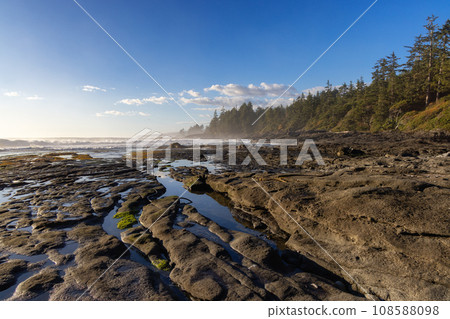 Rocky Shore on the Pacific Ocean Coast. Sunny Sunset. Nature Background Rocky Shore on the Pacific Ocean Coast. Sunny Sunset. Nature Background 108588098