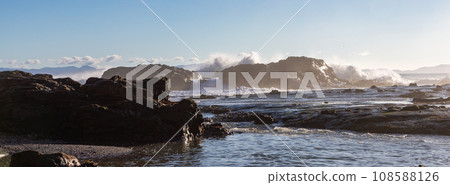 Rocky Shore on the Pacific Ocean Coast. Sunny Sunset. Nature Background Rocky Shore on the Pacific Ocean Coast. Sunny Sunset. Nature Background 108588126
