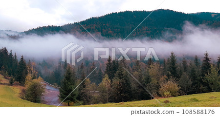 Morning foggy clouds in autumn mountain countryside. Ukraine, Transcarpathia. Morning foggy clouds in autumn mountain countryside. Ukraine, Transcarpathia. 108588176