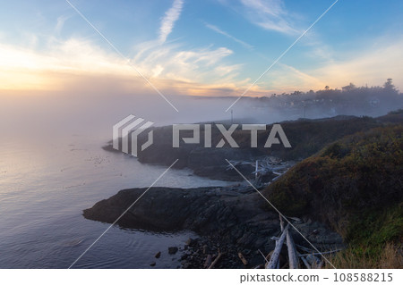Scenic View of the Coastline on the West Pacific Ocean Coast. Foggy Sunset. Scenic View of the Coastline on the West Pacific Ocean Coast. Foggy Sunset. 108588215
