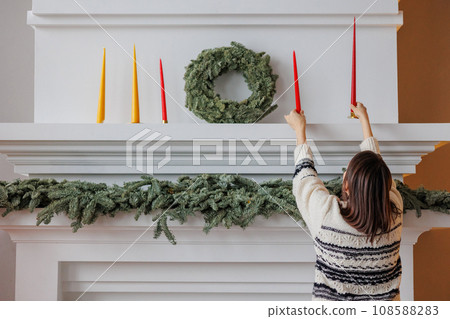 woman decorates Christmas tree and house for holiday New year 108588283