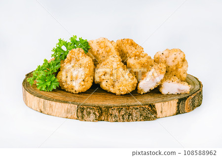 Chicken Breaded Fillet. Breaded chicken nuggets. Fast homemade food at home. Chicken breaded schnitzels. Breaded Chicken Inner Fillet on a White Background,Chicken Breaded Raw Meat. Fast cooking. 108588962