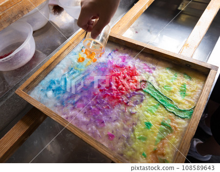 Children experiencing paper making Children experiencing paper making 108589643