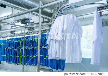 Washed clothes are being conveyed to ironing machine Washed clothes are being conveyed to ironing machine 108589835